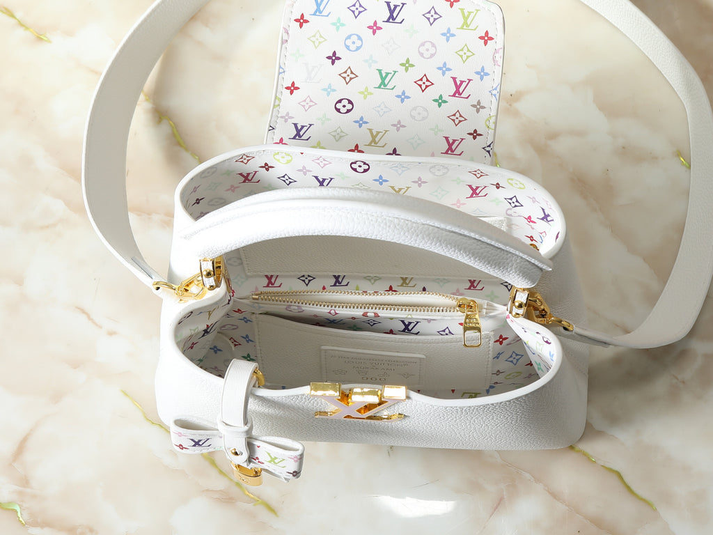 White handbag with multicolor logo pattern on a marble surface