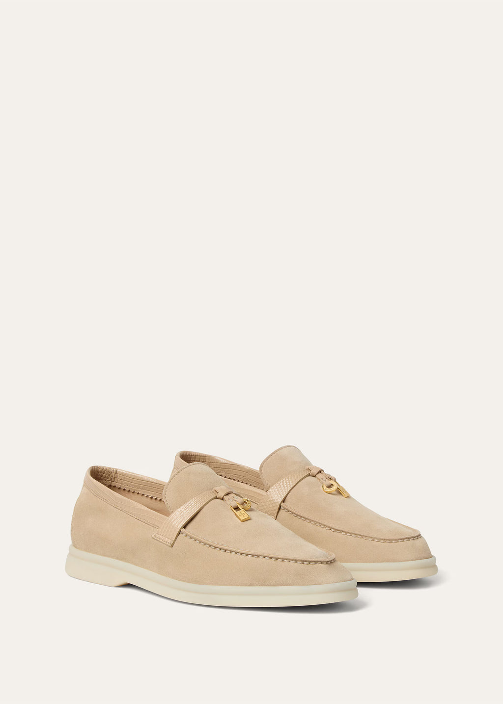 Pair of beige loafers on a light gray background