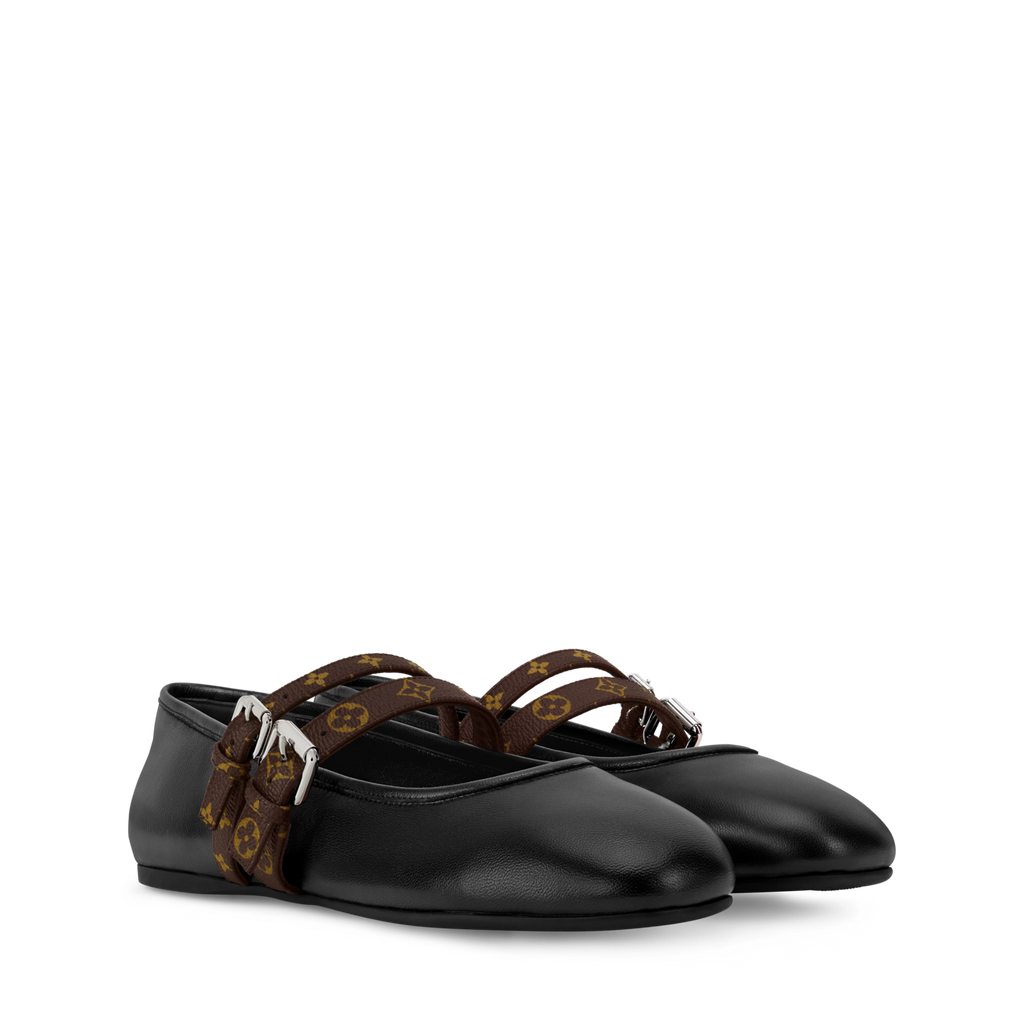 Black ballet flats with brown strap on a white background