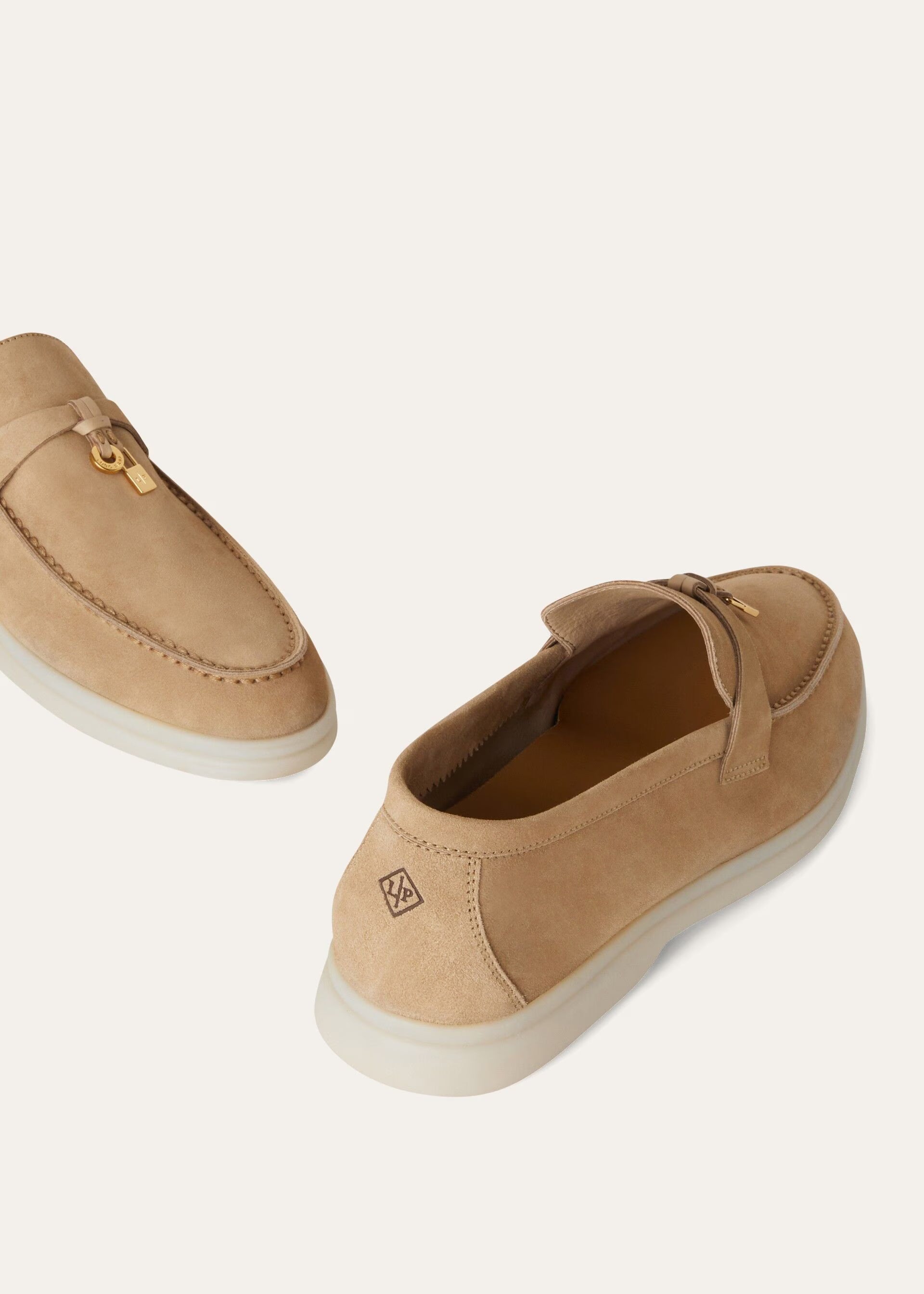 Pair of tan loafers on a white background