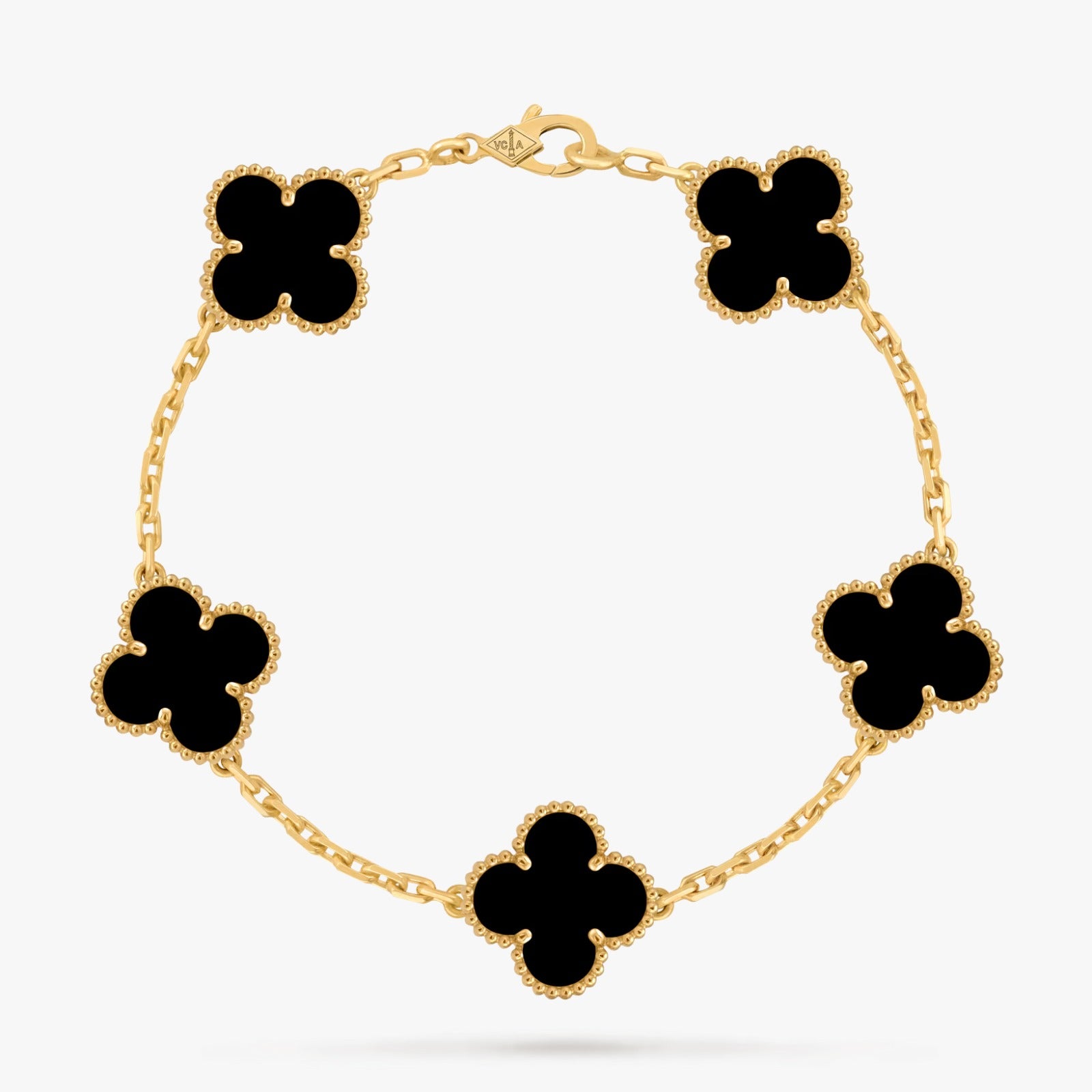 Gold bracelet with black clover-shaped charms on a white background