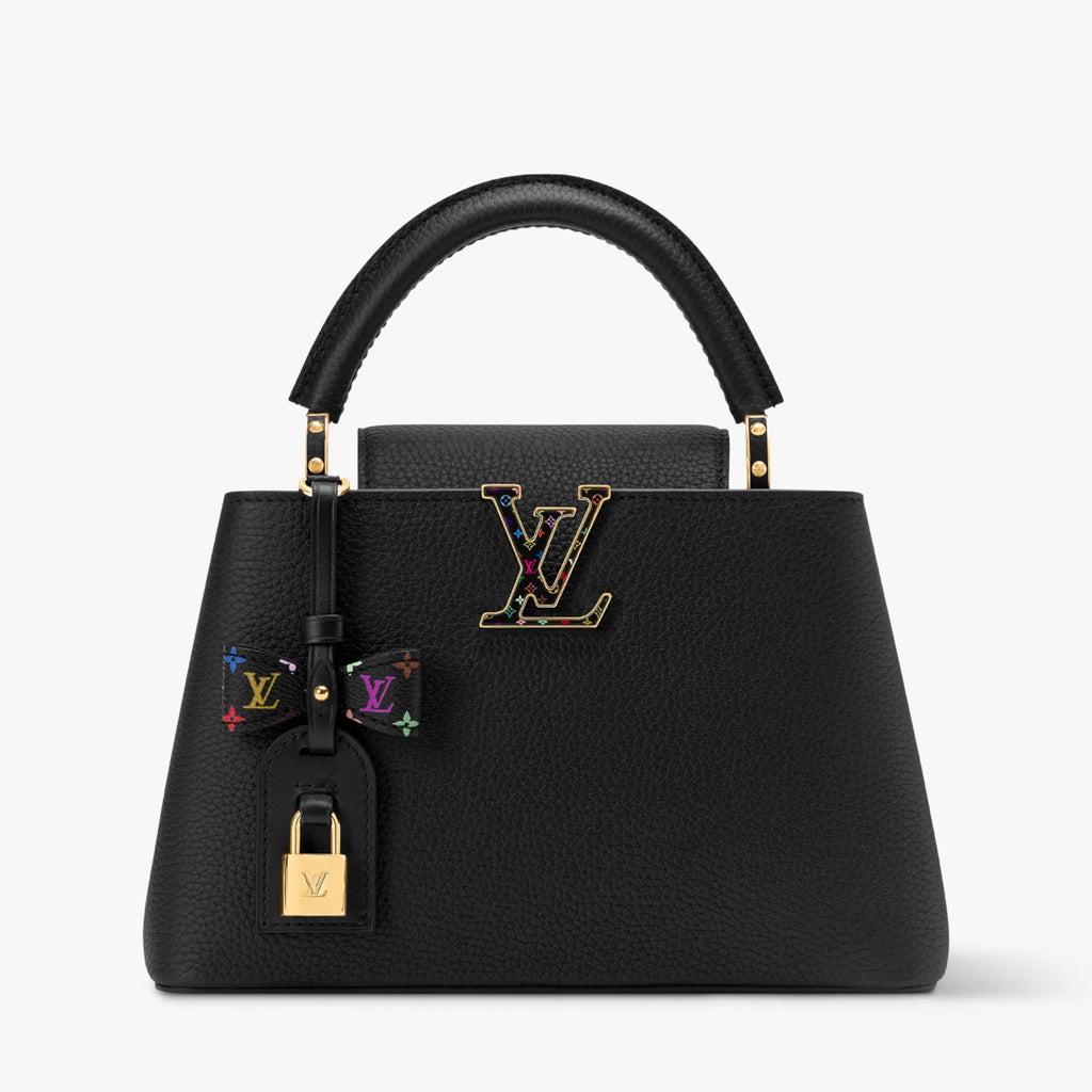 Black handbag with colorful accents and gold hardware on a white background