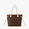 Designer handbag with monogram pattern on a white background